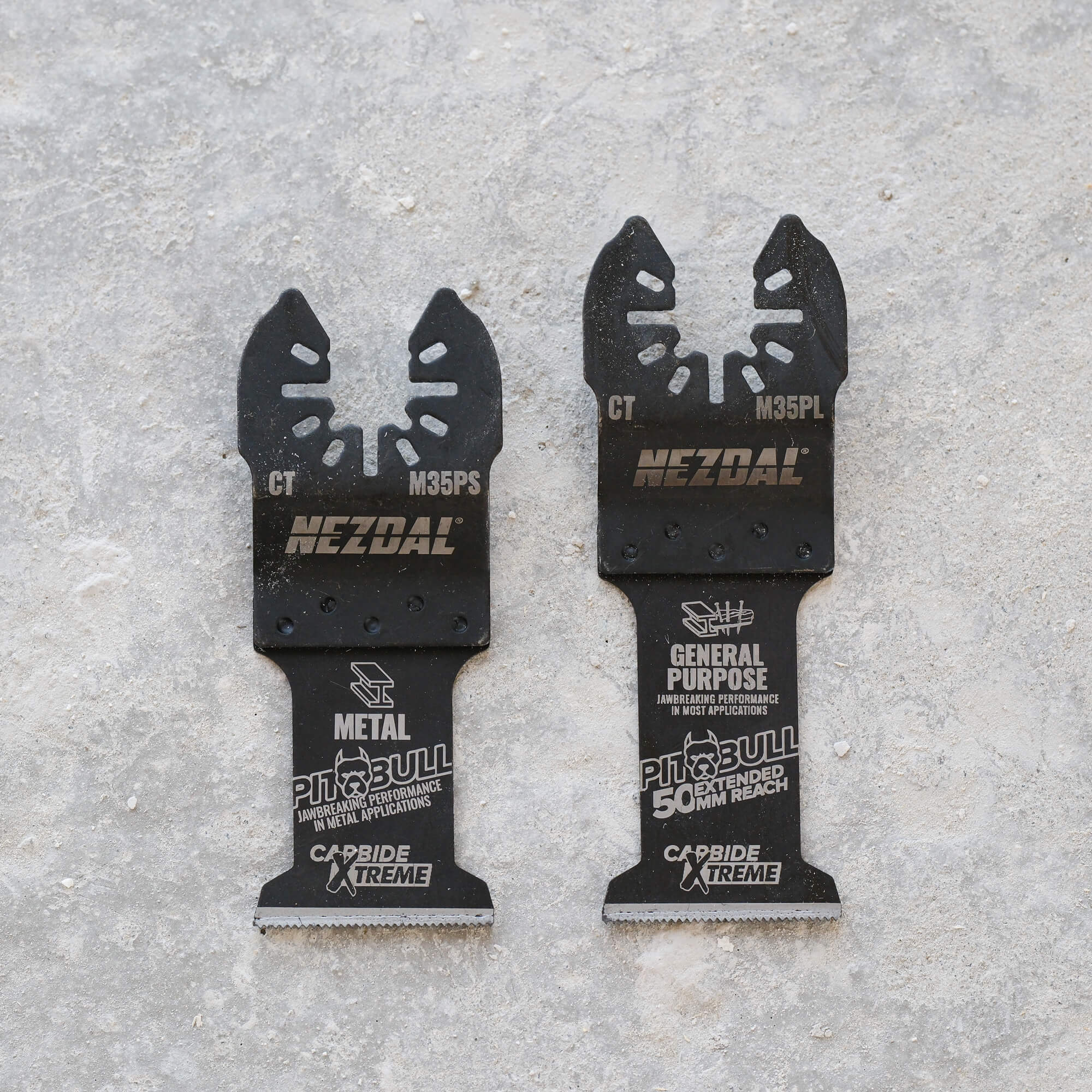 two carbide multi-tool blades on a concrete surface